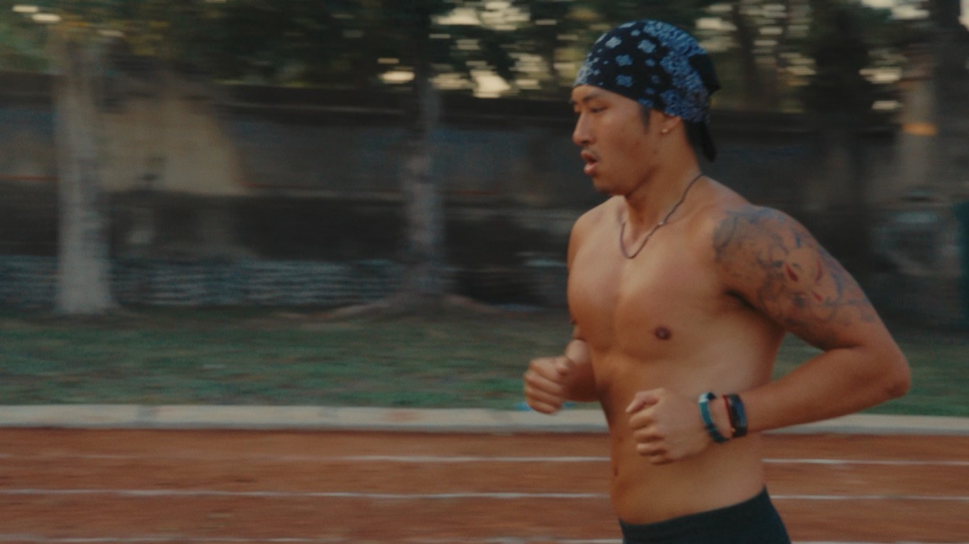 Running on an outdoor track, mid-stride
